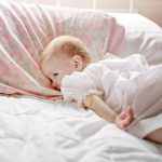 baby bed lying sheets pillows 7388054